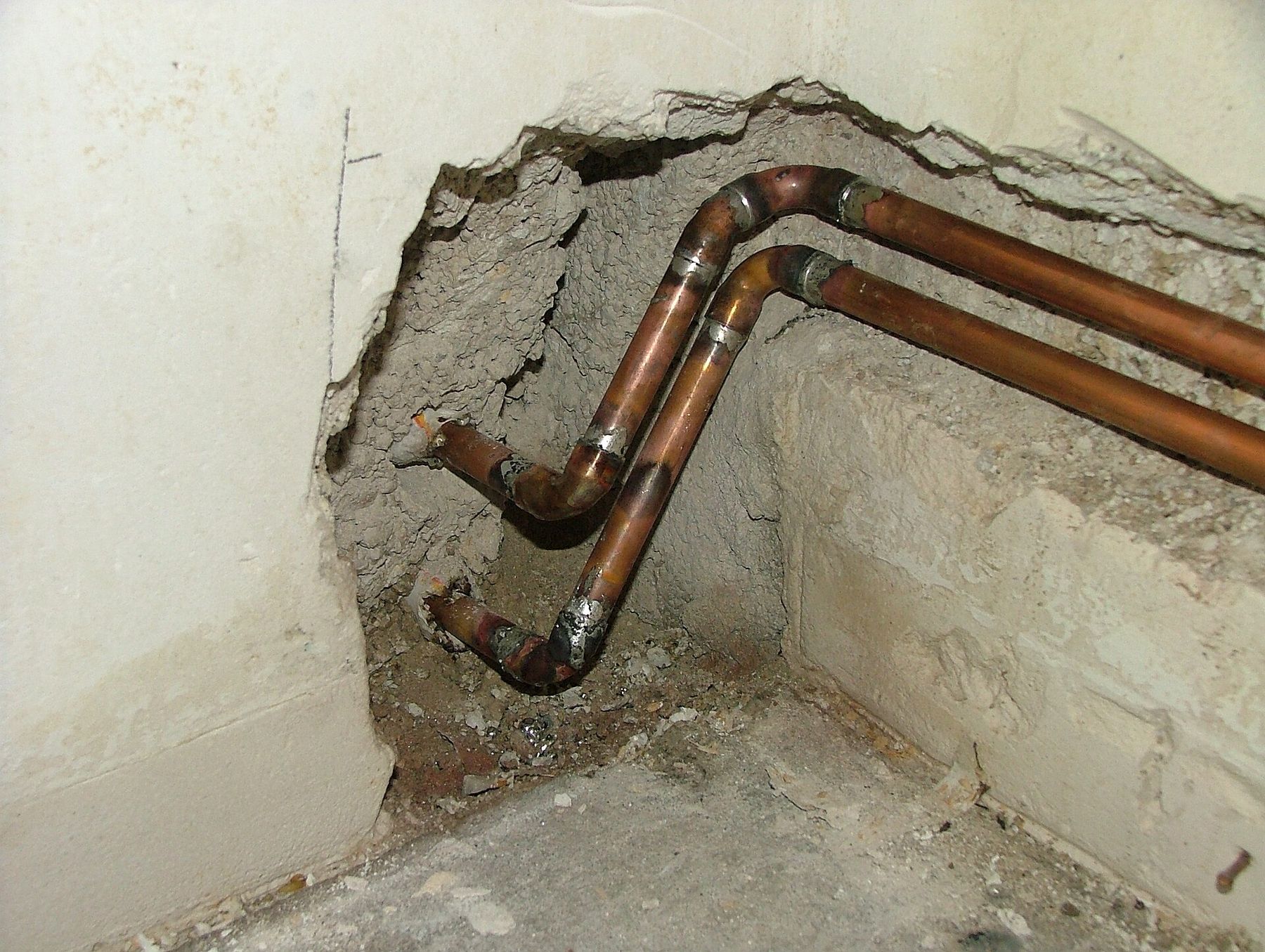 Copper pipes running through an opened wall