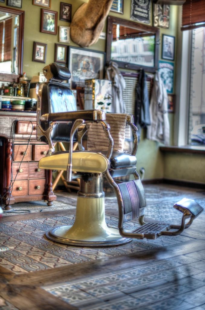 An old barber chair in a shop full of mirrors